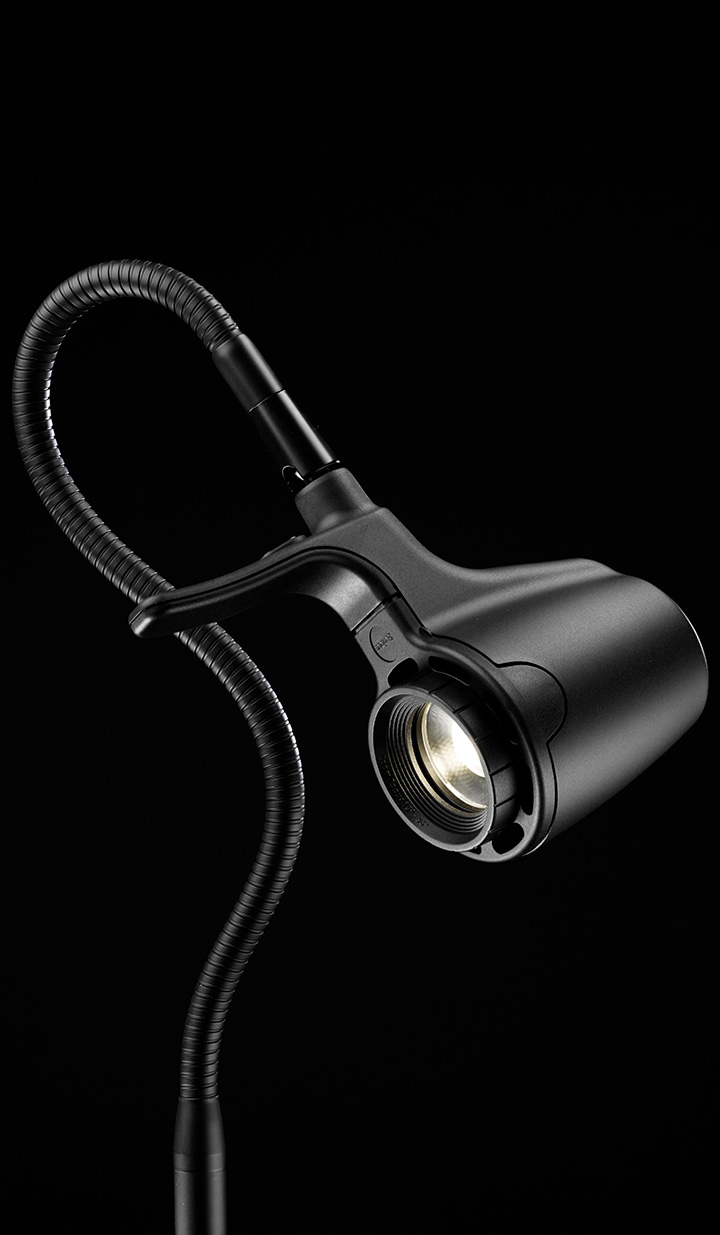 Reader with open broadsheet newspaper under wide daylight beam