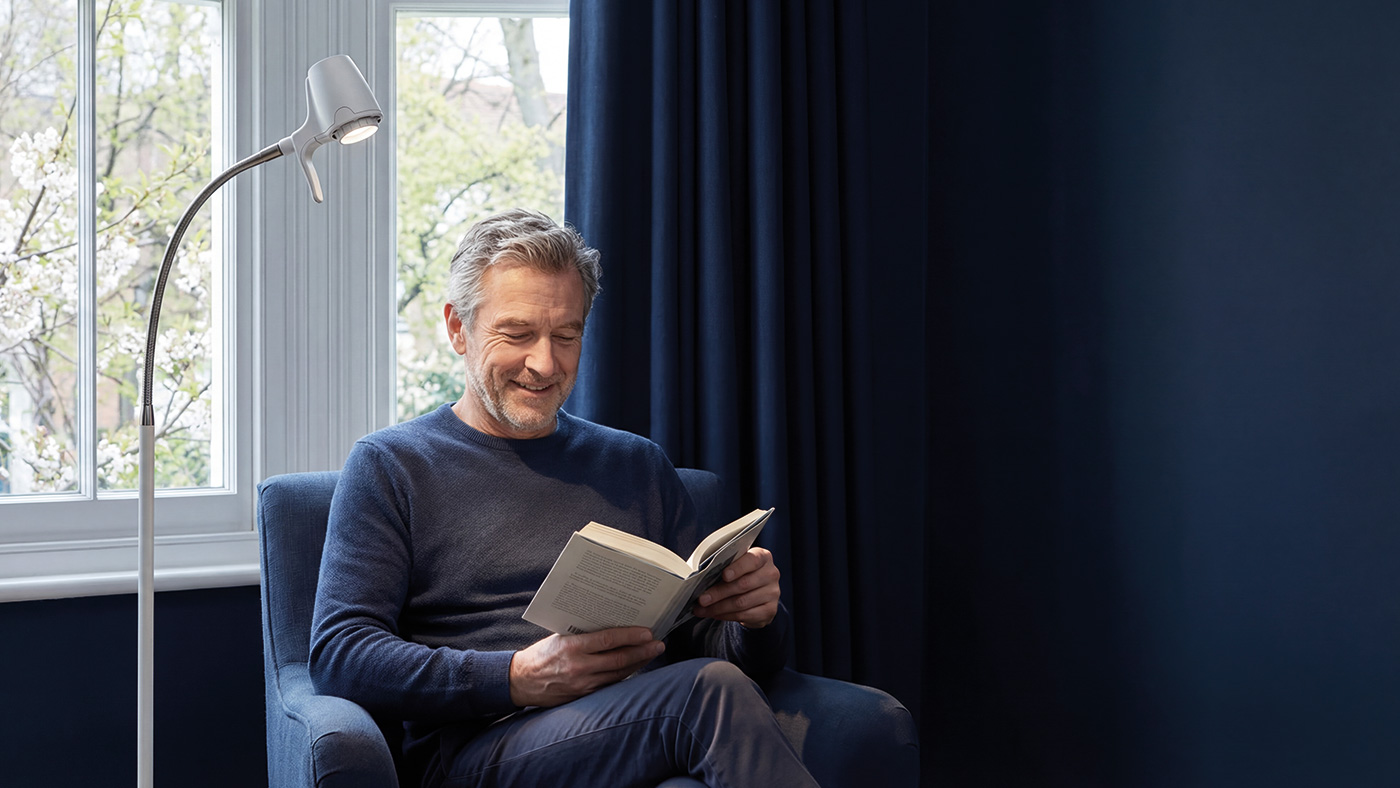 HD Original Lightweight Floor Light in black, showing precision dimmer, swivel joint, variable beam head, and wood carry handle